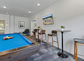 Thumbnail 17 of 33 - a games room with a pool table and bar with stools at EastGate Apartments, Minnesota, 55904