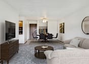 Thumbnail 3 of 25 - a living room with a couch and a table and a television at Pheasant Park Apartments, New Hope, MN, 55428-5401