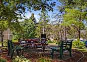 Thumbnail 31 of 32 - a picnic area with benches and tables in a park at Heritage Hills Apartments, Minnesota, 55437