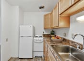 Thumbnail 8 of 21 - a kitchen with a sink and a refrigerator at Humboldt Senior 55+ Apartments, Saint Paul, 55107