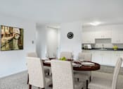 Thumbnail 3 of 21 - a dining room with a table and chairs and a kitchen at Humboldt Senior 55+ Apartments, Saint Paul, MN, 55107