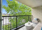 Thumbnail 5 of 21 - a living room with a couch and a table on a balcony at Humboldt Senior 55+ Apartments, Minnesota, 55107