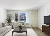 Thumbnail 2 of 21 - a living room with a couch and a coffee table at Humboldt Senior 55+ Apartments, Saint Paul