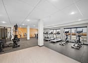 Thumbnail 13 of 19 - A gym with a variety of equipment including treadmills, stationary bikes, and weight machines at The Landing at Amber Fields Apartments, Rosemount, MN, 55068