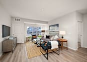 Thumbnail 6 of 19 - A living room with a couch, chair, and television at The Landing at Amber Fields Apartments, Rosemount, MN, 55068