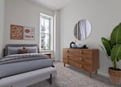 Thumbnail 4 of 21 - A bedroom with a bed, dresser, and mirror. at Parkside Apartments, St. Paul
