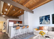 Thumbnail 12 of 21 - a kitchen with a bar and a living room with a couch at Parkside Apartments, St. Paul, Minnesota