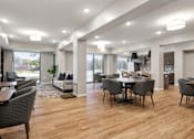 Thumbnail 33 of 44 - A modern living room with a dining table and chairs at Sonder Point 50+ Apartments, Brooklyn Center, MN