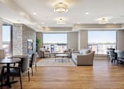 Thumbnail 37 of 44 - A spacious living room with a dining table and chairs at Sonder Point 50+ Apartments, Brooklyn Center, 55430