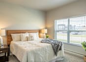 Thumbnail 10 of 51 - a bedroom with a bed and a large window at Technology Park Apartments, Rochester, MN, 55901