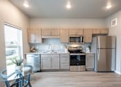 Thumbnail 38 of 51 - a kitchen with stainless steel appliances and white cabinets at Technology Park Apartments, Rochester, Minnesota