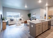 Thumbnail 35 of 51 - an open living room and kitchen with a view of the city at Technology Park Apartments, Rochester, MN, 55901