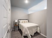 Thumbnail 27 of 51 - a bedroom with a small bed and a white closet at Technology Park Apartments, Minnesota, 55901