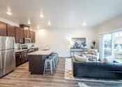 Thumbnail 41 of 51 - a kitchen and living room with stainless steel appliances and a large window at Technology Park Apartments, Minnesota, 55901