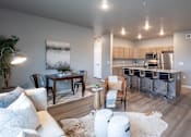 Thumbnail 32 of 51 - an open living room and kitchen with a dining room table and chairs at Technology Park Apartments, Rochester