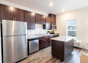 Thumbnail 43 of 51 - a kitchen with stainless steel appliances and wooden cabinets at Technology Park Apartments, Rochester, MN