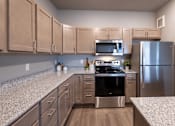 Thumbnail 30 of 51 - a kitchen with granite counter tops and stainless steel appliances at Technology Park Apartments, Rochester, 55901