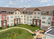Thumbnail 44 of 44 - an aerial view of an apartment building on a green lawn at The Winslow 62+ Apartments, West St Paul