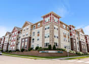 Thumbnail 42 of 44 - an apartment building on the corner of a street at The Winslow 62+ Apartments, West St Paul, MN