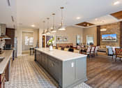 Thumbnail 34 of 44 - a large kitchen with a center island and a dining room at The Winslow 62+ Apartments, West St Paul