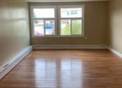 Thumbnail 7 of 57 - an empty living room with wooden floors and a window