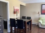 Thumbnail 3 of 57 - a dining room and living room with a table and chairs