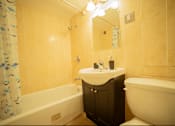 Thumbnail 29 of 57 - A bathroom with a white sink and a white bathtub.