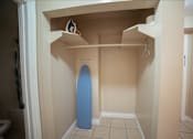 Thumbnail 45 of 57 - A blue surfboard is leaning against the wall in a small room.
