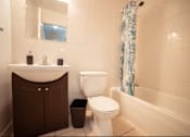 Thumbnail 46 of 57 - A white toilet sits next to a sink in a bathroom.