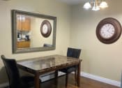 Thumbnail 4 of 57 - a dining room with a table and chairs and a clock on the wall