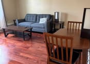 Thumbnail 9 of 57 - a living room with a dining room table and a couch