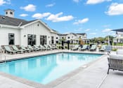 Thumbnail 51 of 113 - A large white building with a pool in front.