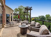 Thumbnail 45 of 49 - a patio with wicker furniture and a table on a balcony