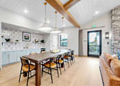 Thumbnail 76 of 113 - A modern kitchen with a dining table and chairs.