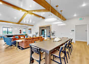 Thumbnail 74 of 113 - A dining room with a long table and chairs.