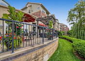 Thumbnail 30 of 49 - a patio with tables and chairs and a fence