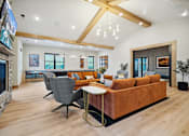 Thumbnail 41 of 52 - A modern living room with a stone fireplace and a large sectional sofa.