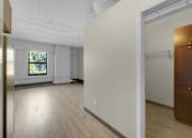 Thumbnail 14 of 55 - A room with a wooden floor and a window.