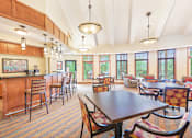 Thumbnail 24 of 49 - a dining room with a table and chairs and a kitchen