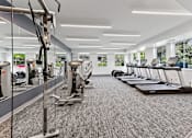 Thumbnail 61 of 83 - a gym with treadmills and elliptical machines at Audenn Apartments, Bloomington