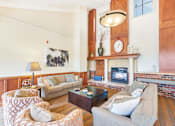 Thumbnail 27 of 49 - a living room with couches and a fireplace
