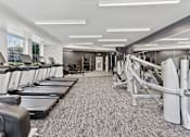 Thumbnail 62 of 83 - a gym with treadmills and other exercise equipment at Audenn Apartments, Minnesota, 55438