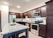 Thumbnail 65 of 82 - kitchen with espresso cabinetry and accent island at Lake Jonathan Flats, Chaska, Minnesota