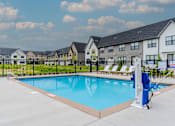 Thumbnail 40 of 48 - Pool With Lounge Chairs at Foxtail Hollow Townhomes, Blaine, MN