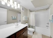 Thumbnail 28 of 55 - A white sink with a mirror above it and a white toilet next to it.