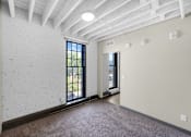 Thumbnail 22 of 55 - A room with a white brick wall and a window.