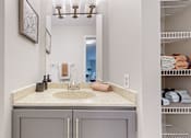 Thumbnail 54 of 83 - a bathroom with a sink and a mirror at Audenn Apartments, Bloomington, MN