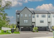 Thumbnail 46 of 48 - A modern two-story house with a garage and a driveway. at Foxtail Hollow Townhomes, Minnesota
