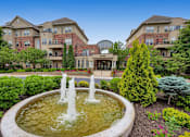 Thumbnail 42 of 49 - a fountain in front of an apartment building