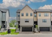 Thumbnail 48 of 48 - A modern two-story house with a garage is shown. at Foxtail Hollow Townhomes, Blaine, MN